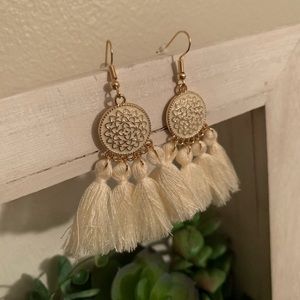Gorgeous golden earrings with cream colored tassels!
